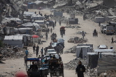 Displaced Palestinians flee their homes in the town of Beit Lahia, north of Gaza City,