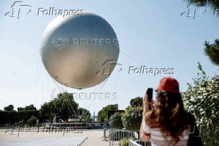 The return of a new Paris 2024 flame cauldron set on a balloon to the Tuileries Garden and the Paris skyline