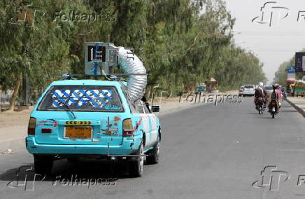 Taxi drivers install locally made air coolers to beat the heat in Kandahar