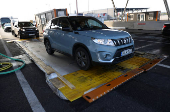 Cars drive through a disinfectant mat during the outbreak of foot-and-mouth disease at the Austrian-Hungarian border