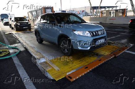 Cars drive through a disinfectant mat during the outbreak of foot-and-mouth disease at the Austrian-Hungarian border