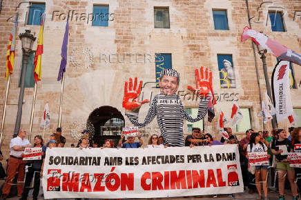 Protesters rally outside the gates of the Valencia regional parliament to demand the resignation of regional leader Carlos Mazon