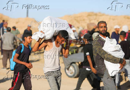 Palestinians receive aid from the U.S.-backed Gaza Humanitarian Foundation, in Khan Younis