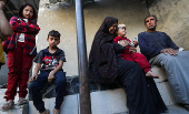Palestinians inspect the damage at the site of an Israeli strike on a house, in Jabalia