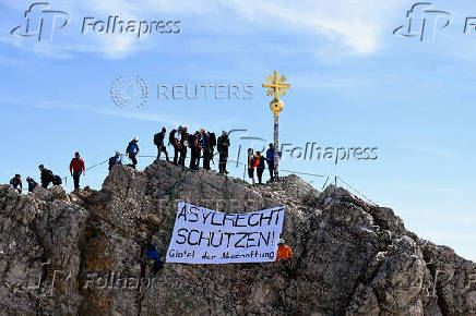 People display a banner reading: 