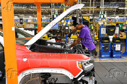 FILE PHOTO: Components are installed around the engine on the assembly line at the General Motors (GM) manufacturing plant in Spring Hill