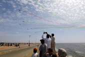 FILE PHOTO: People take photos as Pakistan Air Force jets perform at an air show