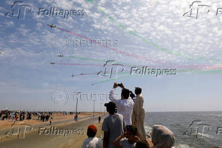 FILE PHOTO: People take photos as Pakistan Air Force jets perform at an air show