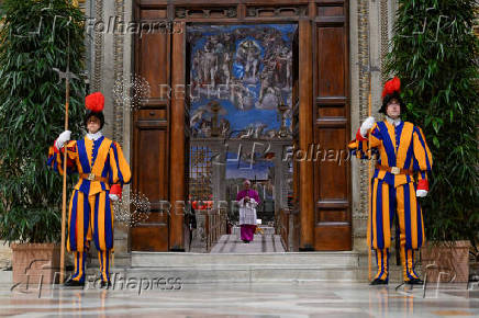 Swiss guards stand at the Sistine Chapel, ahead of the conclave to elect the next pope at the Vatican