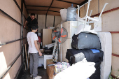 Syrian returnee Ahmed Al-hadid, loads his belongings onto a truck, in Aleppo's countryside