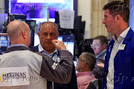 Traders work on the floor of the NYSE in New York