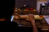 Technician checks a prosthetic limb at the Bioniks Private Limited, in Karachi