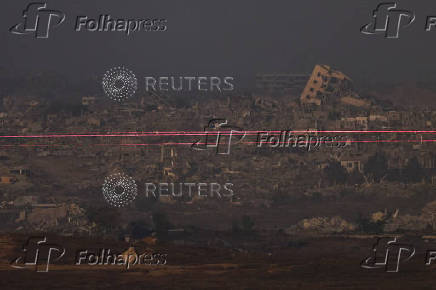 Beams of light are seen from the Israeliside of the Israel-Gaza border