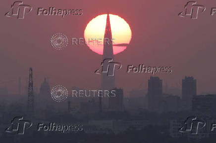The sun sets behind the business tower Lakhta Centre in Saint Petersburg