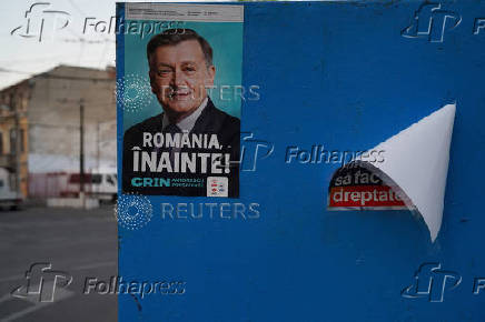 An electoral poster of Crin Antonescu is seen on a wall in Bucharest