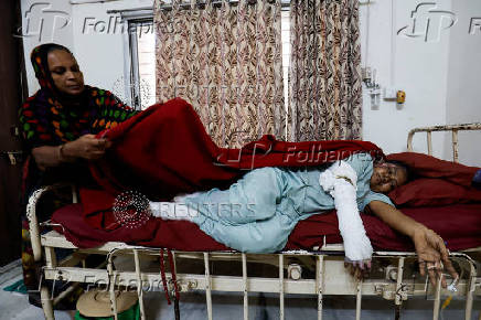 Sita Patni, 45, who was injured after an Air India Boeing 787-8 Dreamliner plane crashed during takeoff from an airport, receives treatment in a private hospital, in Ahmedabad
