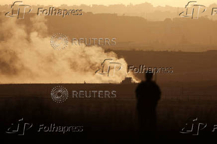 Israeli soldier overlooks the Gaza Strip, as seen from the Israeli side of the Israel-Gaza border