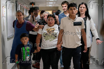 A migrant family departs after being briefly detained by federal immigration officers at U.S. immigration court in Manhattan