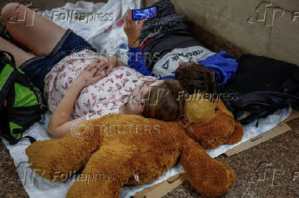 People take shelter inside a metro station during an air raid alert in Kyiv