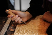 Afghan girl teach Nuristani wood carving skills at a workshop in Kabul