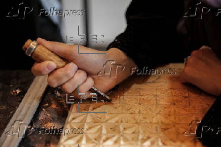 Afghan girl teach Nuristani wood carving skills at a workshop in Kabul