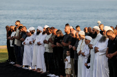 Israeli Muslims pray on the first day of the Muslim holiday of Eid al-Adha by the sea side of the Mediterranean, in Jaffa