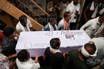 Family members carry the coffin of Ranvirsinh Chavda in Ahmedabad