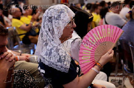 People sit inside the St. Peter's Basilica during Jubilee of Youth, at the Vatican