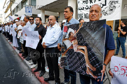 People take part in a protest against what organizers call 