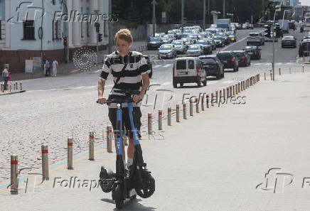 A person rides an e-scooter in Kyiv