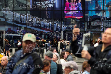 U.S. Navy sailors line up for a group portrait in Times Square during Fleet Week 2025