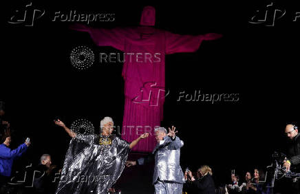 Models present creations by Alessa at the Christ the Redeemer statue to mark the launch of Rio Fashion Show, in Rio de Janeiro