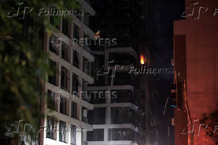 Fire seen in a building at an impact site following a missile attack from Iran on Israel, at Tel Aviv