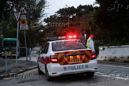A police officer stands guard outside Stanley Prison during the release of former lawmakers Kwok Ka-ki and Jeremy Tam, convicted in a landmark national security case, in Hong Kong
