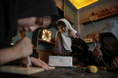 Afghan girl teach Nuristani wood carving skills at a workshop in Kabul