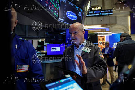 Traders work on the floor at the New York Stock Exchange (NYSE) in New York City