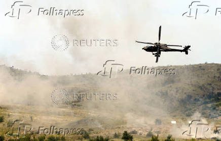 A Greek Apache helicopter flies as NATO holds training exercise 'Immediate Response' drills with host nations Albania, Bulgaria, Croatia, Greece, Kosovo, Montenegro, and North Macedonia, at Krivolak army base