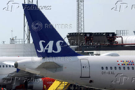 FILE PHOTO: The tail fin of a Scandinavian Airlines (SAS) airplane parked on the tarmac at Copenhagen Airport Kastrup in Copenhagen