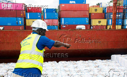 Workers unload a shipment of rice from the MV Amira Sophie II, at the Kenya Ports Authority (KPA) container terminal in the port of Mombasa