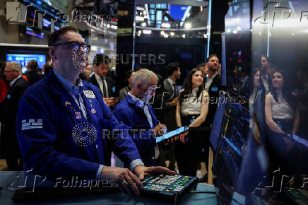Traders work on the floor at the New York Stock Exchange (NYSE) in New York City
