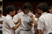 Secondary school students react after receiving their Diploma of Secondary Education (DSE) exam results in Hong Kong