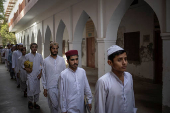 Students walk to their classes at a madrasa in Multan