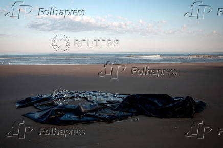 FILE PHOTO: A damaged zodiac boat left behind by migrants trying to cross the English Channel