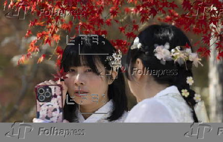 Tourists in Hanbok take selfies at Seoul’s Gyeongbokgung Palace