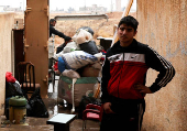 FILE PHOTO: Former Assad regime officers vacate homes for incoming rebel families