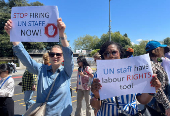 UN staff demonstrate about firing employees, outside the European headquarters, in Geneva
