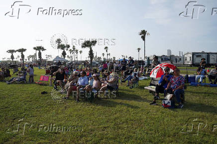 People wait to watch SpaceX's next-generation Starship spacecraft atop its Super Heavy booster launch