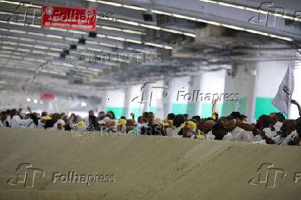 Muslim pilgrims hurl stones during 'stoning of the devil' ritual, in Mina