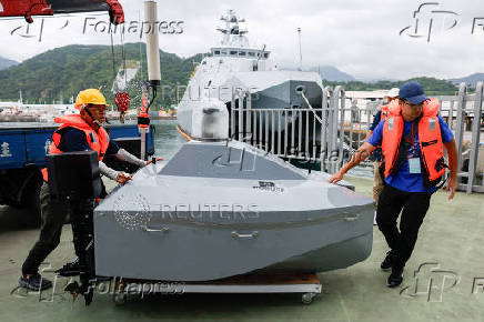 Staff move the Carbon Voyager I, developed by Carbon-Based Technology, during a sea drone event in Yilan