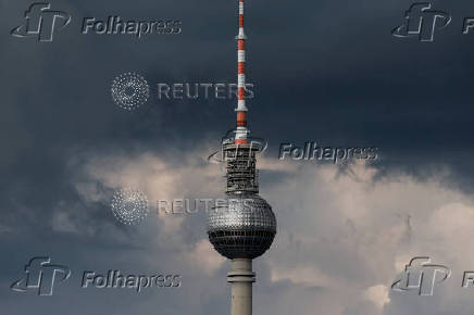 Berlin's television tower amid dark clouds, in Berlin